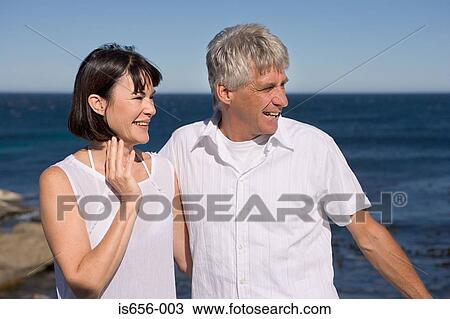 Stock Image - Mature couple by the sea. Fotosearch