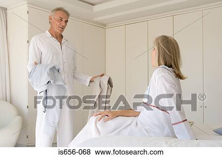 Stock Photo - Mature couple in bedroom . Fotosearch