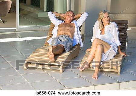 Picture - Mature couple in lounge chairs. Fotosearch