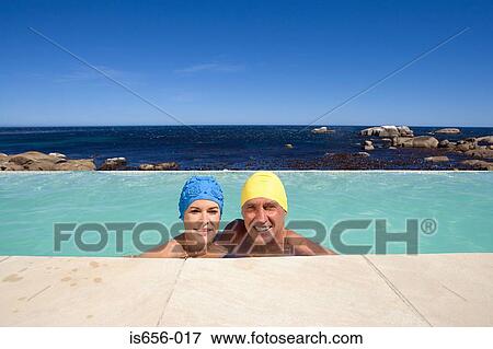Stock Photo - Mature couple in swimming caps . Fotosearch