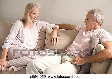 Stock Photo - Mature couple on sofa. Fotosearch