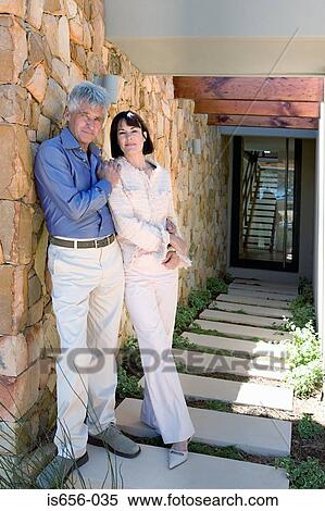 Stock Photography - Mature couple outside house. Fotosearch