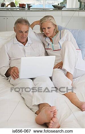 Mature couple using laptop View Large Photo Image Stock Photo - Mature couple using laptop. Fotosearch