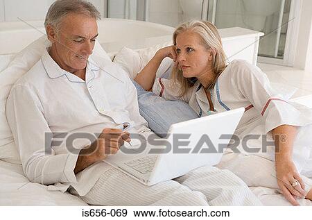 Mature couple with laptop View Large Photo Image Stock Photo - Mature couple with laptop. Fotosearch
