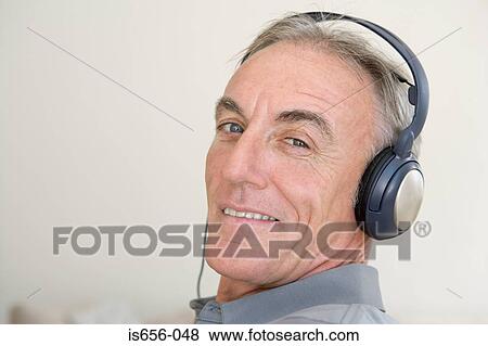 Mature man wearing headphones View Large Photo Image Stock Photo - Mature man wearing headphones. Fotosearch