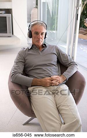 Mature man wearing headphones View Large Photo Image Stock Photography - Mature man wearing headphones. Fotosearch