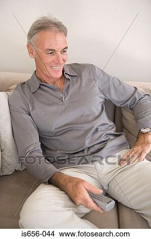 Mature man with remote control View Large Photo Image Picture - Mature man with remote control. Fotosearch