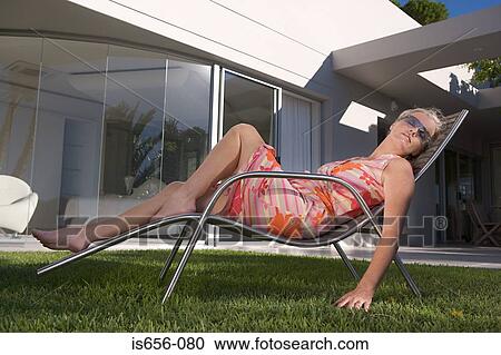 Mature woman in lounge chair View Large Photo Image Stock Image - Mature woman in lounge chair. Fotosearch