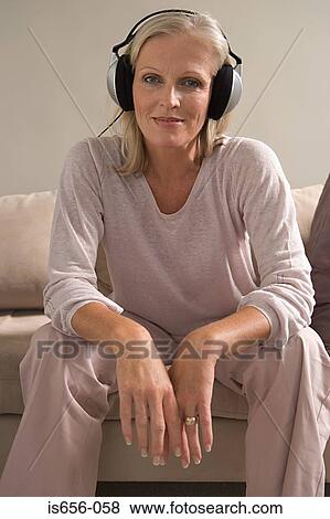 Mature woman wearing headphones View Large Photo Image Stock Photo - Mature woman wearing headphones. Fotosearch