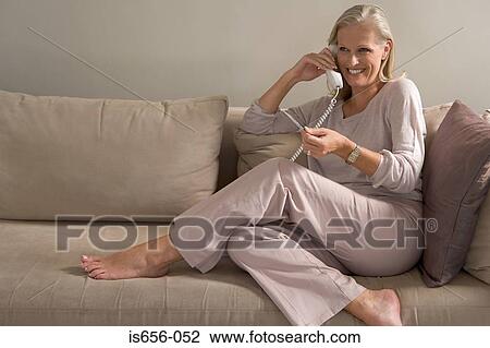 Woman on phone holding credit card View Large Photo Image Stock Image - Woman on phone holding credit card. Fotosearch