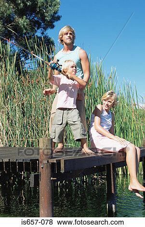 Stock Photo - Boy fishing with mother and father. Fotosearch