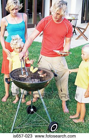 Stock Image - Family having barbecue. Fotosearch