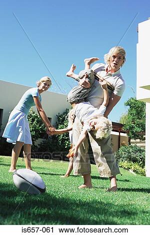 Family playing in garden View Large Photo Image Stock Image - Family playing in garden. Fotosearch
