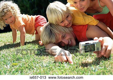 Stock Image - Family taking photographs. Fotosearch
