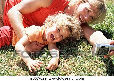 Stock Photo - Father and daughter taking photographs. Fotosearch