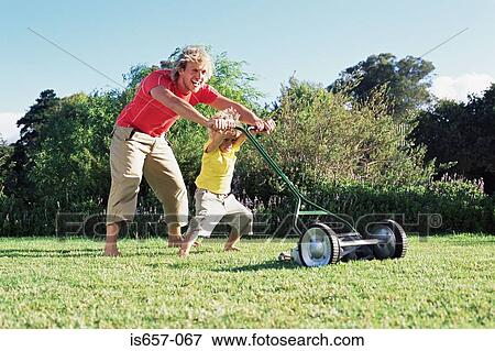 Stock Photo - Father and son mowing lawn. Fotosearch