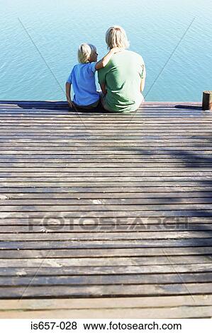 Stock Photo - Father and son on a jetty. Fotosearch
