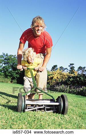 Father and son pushing lawn mower View Large Photo Image Picture - Father and son pushing lawn mower. Fotosearch