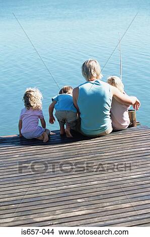 Picture - Father with children on a jetty. Fotosearch