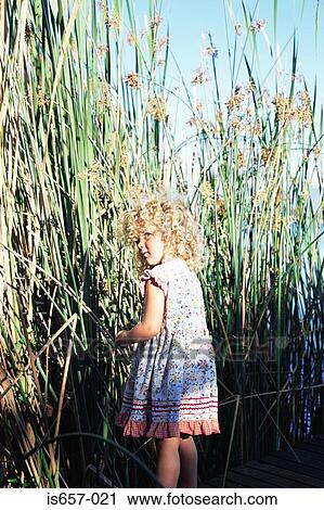 Stock Image - Girl by reeds. Fotosearch
