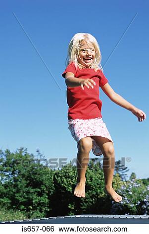 Girl on a trampoline View Large Photo Image Stock Photograph - Girl on a trampoline. Fotosearch