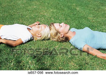 Mother and daughter asleep on lawn View Large Photo Image Stock Photograph - Mother and daughter asleep on lawn. Fotosearch