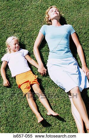Mother and daughter asleep on lawn View Large Photo Image Stock Photography - Mother and daughter asleep on lawn. Fotosearch