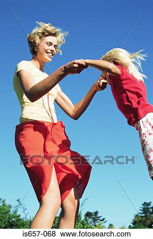 Mother and daughter jumping View Large Photo Image Stock Photo - Mother and daughter jumping. Fotosearch