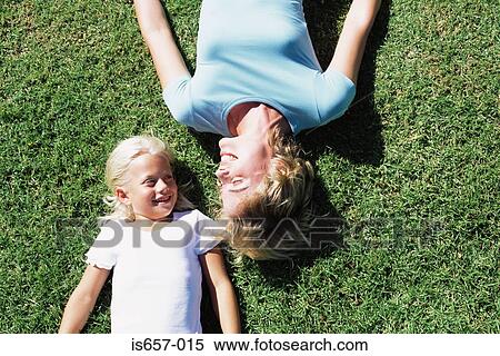 Mother and daughter lying on lawn View Large Photo Image Stock Photography - Mother and daughter lying on lawn. Fotosearch