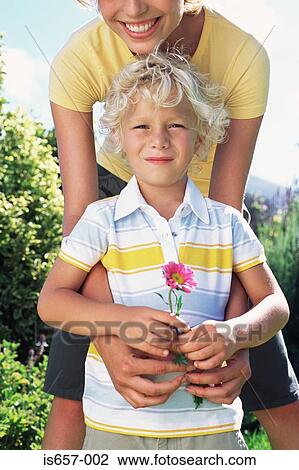 Mother and son with flower View Large Photo Image Stock Image - Mother and son with flower. Fotosearch