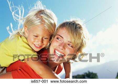 Mother giving daughter a piggyback View Large Photo Image Stock Image - Mother giving daughter a piggyback. Fotosearch