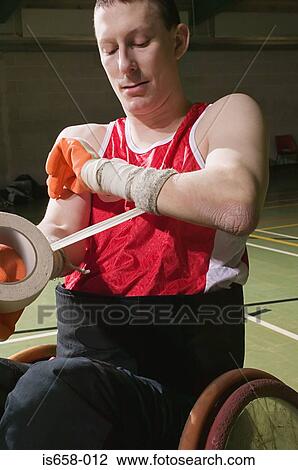 Basketball player bandaging his arm View Large Photo Image Stock Image - Basketball player bandaging his arm. Fotosearch