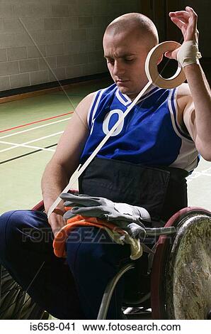Stock Image - Basketball player bandaging his arm. Fotosearch