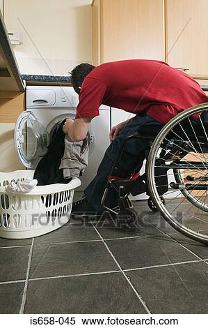 Disabled man doing his laundry View Large Photo Image Stock Photography - Disabled man doing his laundry. Fotosearch