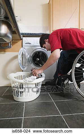 Disabled man doing laundry View Large Photo Image Picture - Disabled man doing laundry. Fotosearch