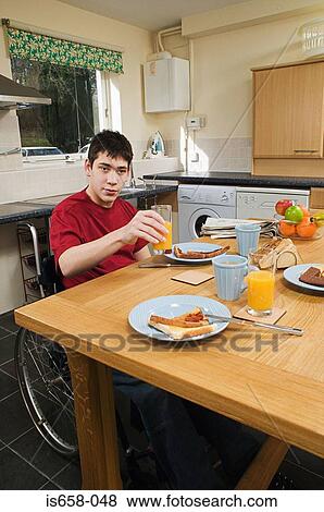 Disabled man having breakfast View Large Photo Image Stock Photo - Disabled man having breakfast. Fotosearch