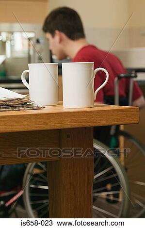 Disabled man in his kitchen View Large Photo Image Stock Image - Disabled man in his kitchen. Fotosearch