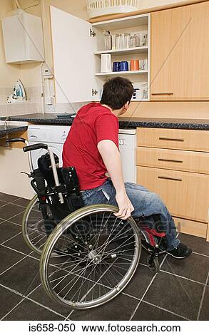 Disabled man in his kitchen View Large Photo Image Stock Image - Disabled man in his kitchen. Fotosearch
