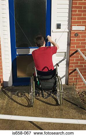 Disabled man opening his front door View Large Photo Image Stock Photo - Disabled man opening his front door. Fotosearch