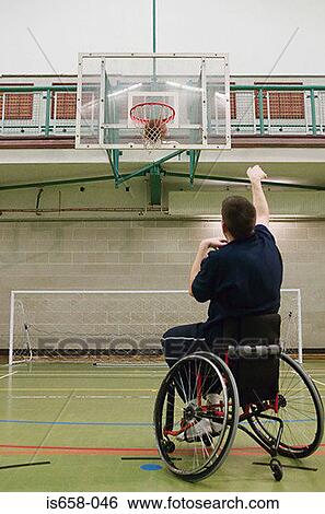 Stock Photograph - Disabled man playing basketball. Fotosearch