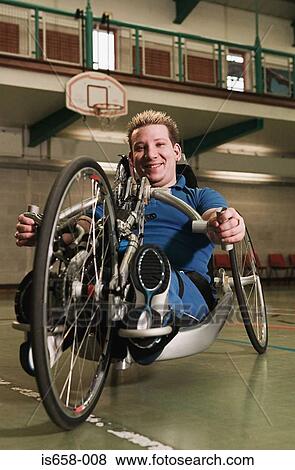 Stock Photo - Disabled man using adapted bicycle. Fotosearch