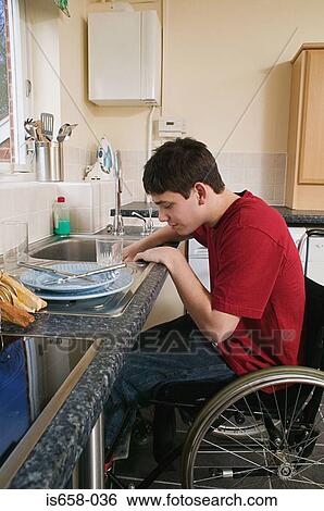 Stock Photograph - Disabled man washing up. Fotosearch