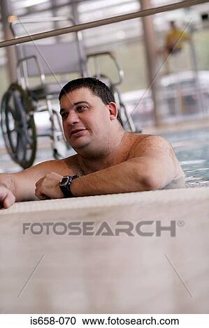 Man resting on the edge of a swimming pool View Large Photo Image Stock Image - Man resting on the edge of a swimming pool. Fotosearch