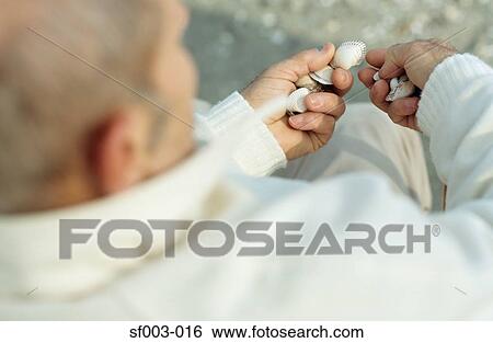 Man holding shells View Large Photo Image Stock Photograph - Man holding shells. Fotosearch