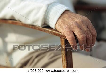 Man's hand resting on chair View Large Photo Image Stock Photo - Man's hand resting on chair. Fotosearch