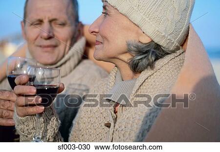 Senior couple drinking wine in blanket View Large Photo Image Stock Image - Senior couple drinking wine in blanket. Fotosearch