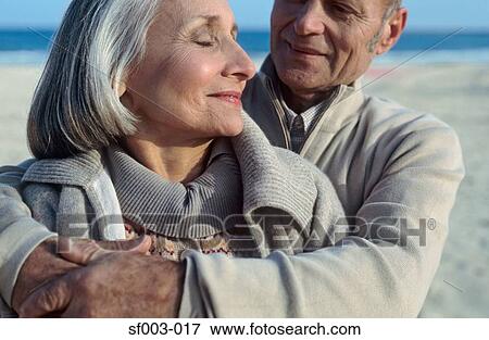 Senior couple hugging on beach View Large Photo Image Stock Photo - Senior couple hugging on beach. Fotosearch