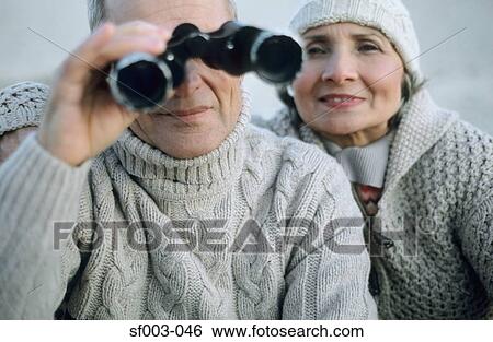 Senior couple using binoculars View Large Photo Image Stock Photograph - Senior couple using binoculars. Fotosearch