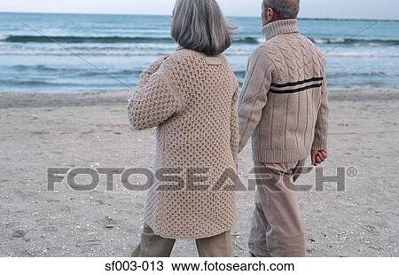 Senior couple walking near sea View Large Photo Image Stock Image - Senior couple walking near sea. Fotosearch