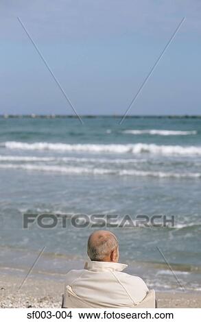 Senior man looking at waves View Large Photo Image Picture - Senior man looking at waves. Fotosearch